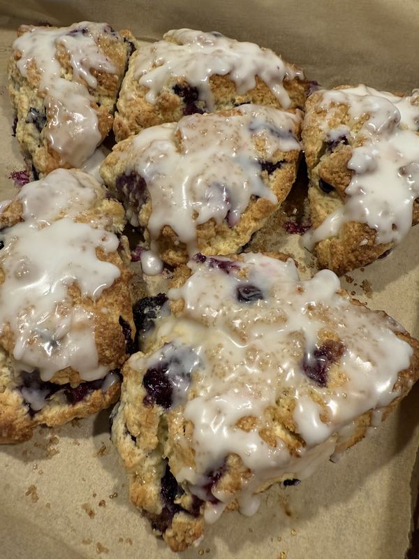 Blueberry scones dripping with sugar glaze
